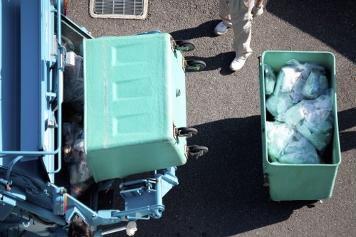 Workers carrying items down stairs during a flat removal in Ilford